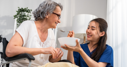 caregiver feeding senior