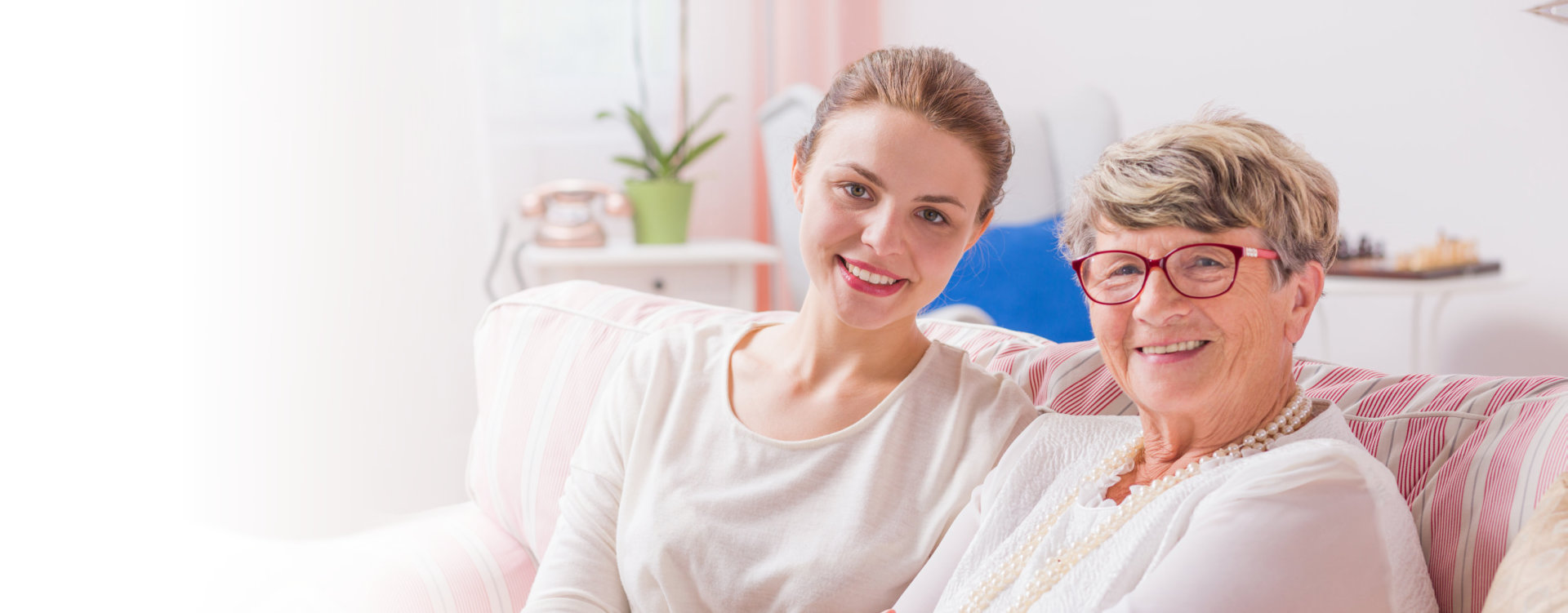 senior woman sitting with her daughter beside her