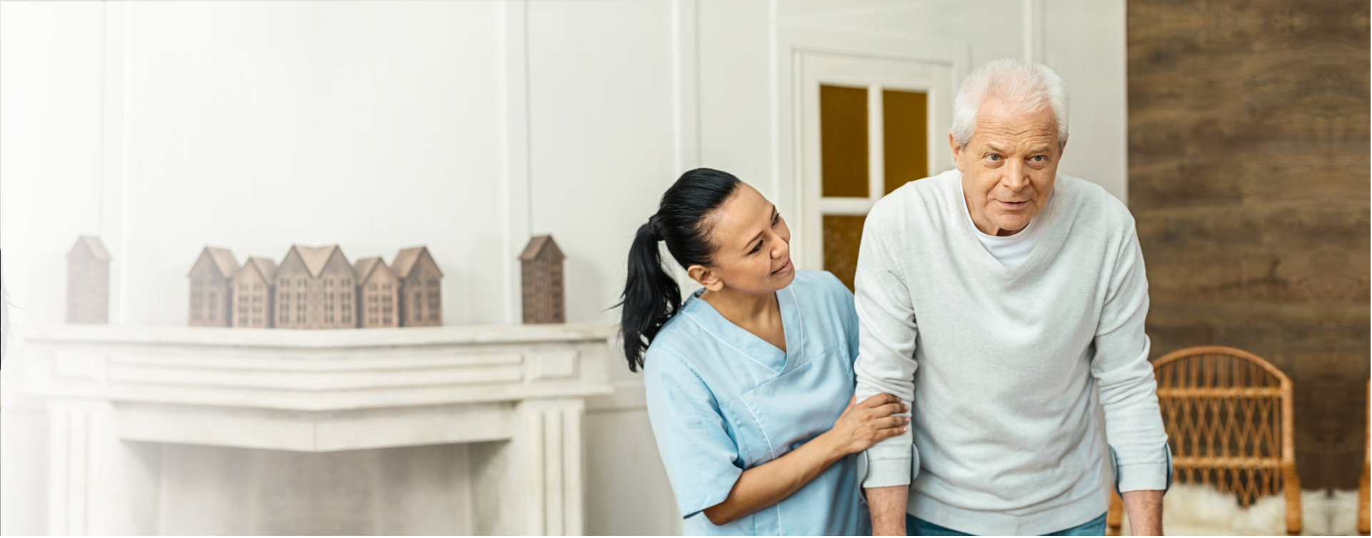 caregiver helping senior man to walk