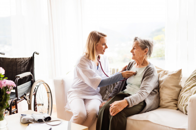 health visitor and a senior woman during home visit