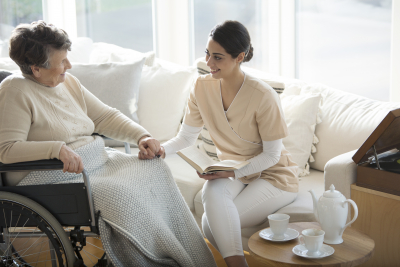 nurse talking with senior on a wheelchair