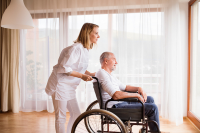 Nurse and senior man in wheelchair 