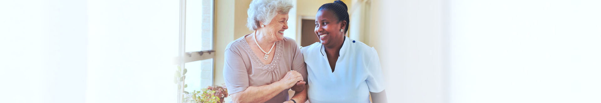 senior woman and caregiver walking together